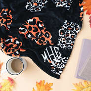 close up of leopard pumpkins monogrammed plush blanket