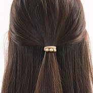 gold hair tie in hair