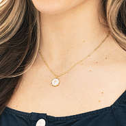 girl wearing personalized cross necklace in white