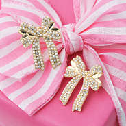 pearl bow earrings on pink present