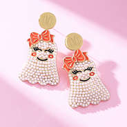 close up of monogrammed pear ghost earrings with bows