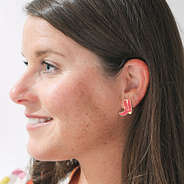 pink cowboy earrings in ear