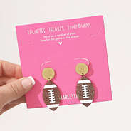 monogrammed football earrings on packaging