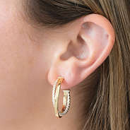 gold and silver cable hoop earrings in ear
