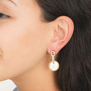 silver and gold cable drop earrings in ear
