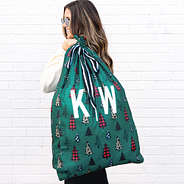 monogrammed gift sack in festive forest over the shoulder