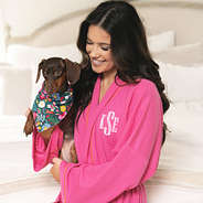 close up of hot pink monogrammed robe with dog