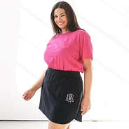 julia wearing black monogrammed athleisure skirt with hot pink shirt