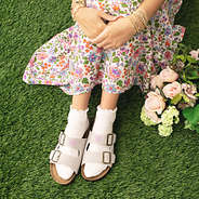 girl wearing monogrammed double strap sandals