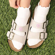 up close of girl wearing monogrammed double strap sandals