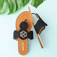 black crochet sandals on blue background