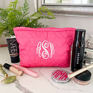 monogrammed heart cosmetic bag on counter with beauty products