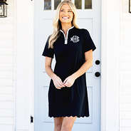 girl wearing monogrammed black quarter zip dress on porch