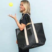 girl with monogrammed waterproof tote in black sp26