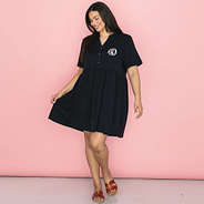 girl in black monogrammed split neck gathered dress