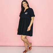 side of black split neck gathered monogrammed dress with sandals