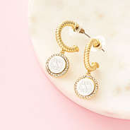 silver and gold cable hoop earrings on marble dish