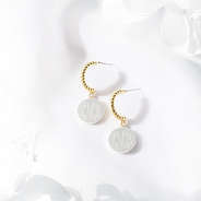 cable hoop earrings on white backdrop