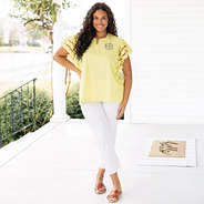girl wearing monogrammed flutter sleeve top in soft yellow with white pants