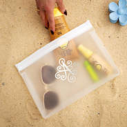 monogrammed white sunscreen bag on sand