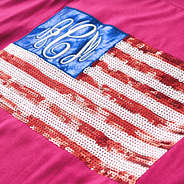 close up of monogrammed hot pink sequin flag shirt