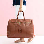 brown weekend travel bag in hand