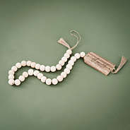 monogrammed wood bead garland on green background