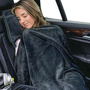 girl with charcoal monogrammed travel blanket pillow in car