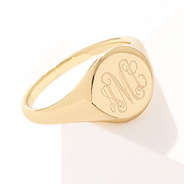 gold monogrammed ring on white background