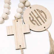up close of wooden cross beaded monogrammed garland