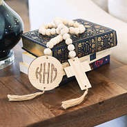wooden cross engraved garland on books