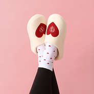 heart socks with monogrammed slippers and crossed ankles
