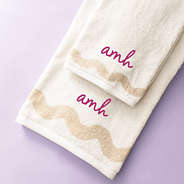 bath towel set on purple background with magenta monogram
