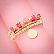heart bracelet set on rolled pink paper