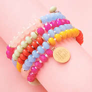 close up of monogrammed coil bracelet in multi