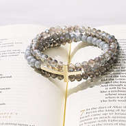 cross bracelet in taupe on bible