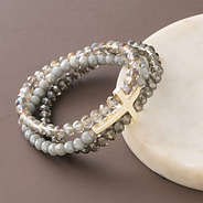 cross bracelet with marble dish on brown