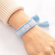 blue personalized woven bracelet on wrist close up