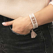 woven khaki monogrammed bracelet on wrist