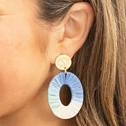 blue raffia earrings in ear