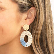 gray raffia earrings in ear
