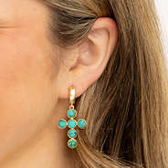 turquoise cross earrings in ear