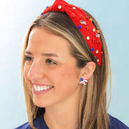 bow patriotic earrings in ear