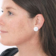 monogrammed nala silver earrings in ears