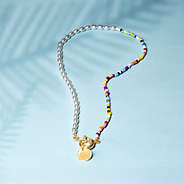 pearl seed bead necklace on blue paper with shadows