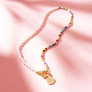 pearl seed bead necklace on print paper with shadows