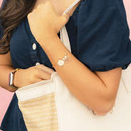 gold shell bracelet set on arm