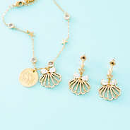 gold shell bracelet on blue background