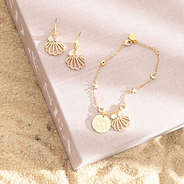 gold shell bracelet set on book