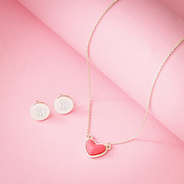 necklace and earrings on rolled pink paper